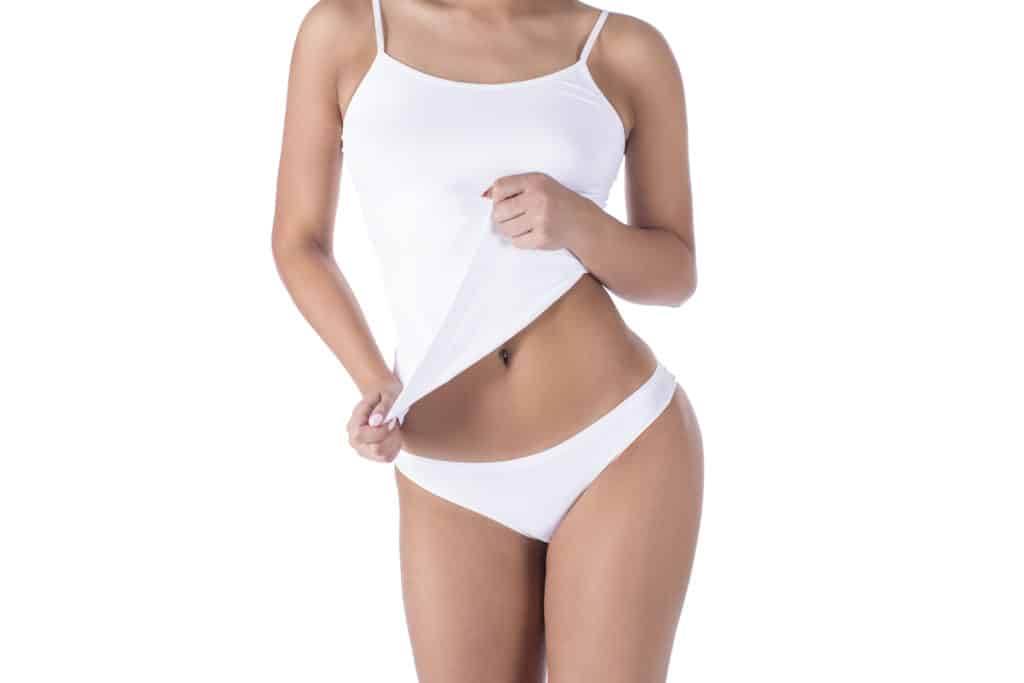 close up of woman from neck down wearing underwear tugging down on upper garment